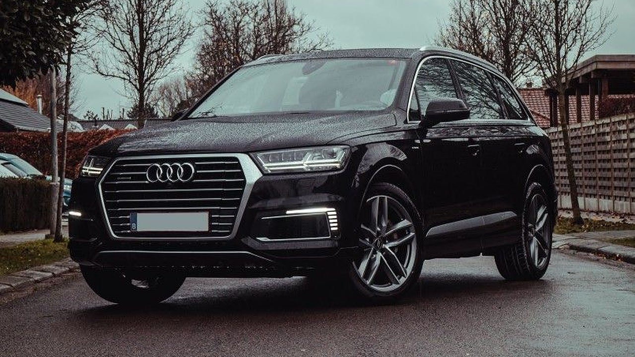 Luxury SUV: Audi Q7 or similar, with a professional driver