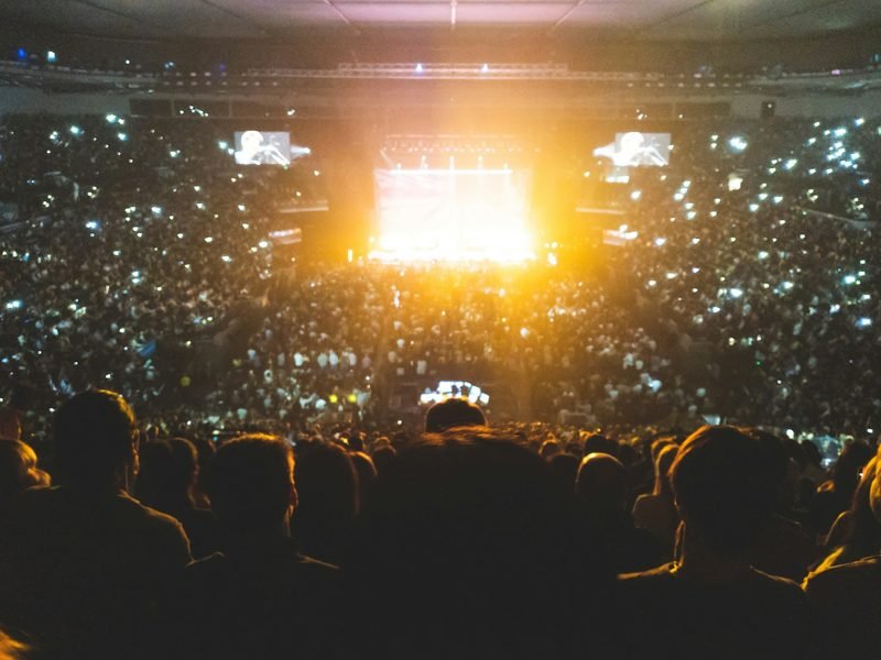 A crowd at a stadium event at night